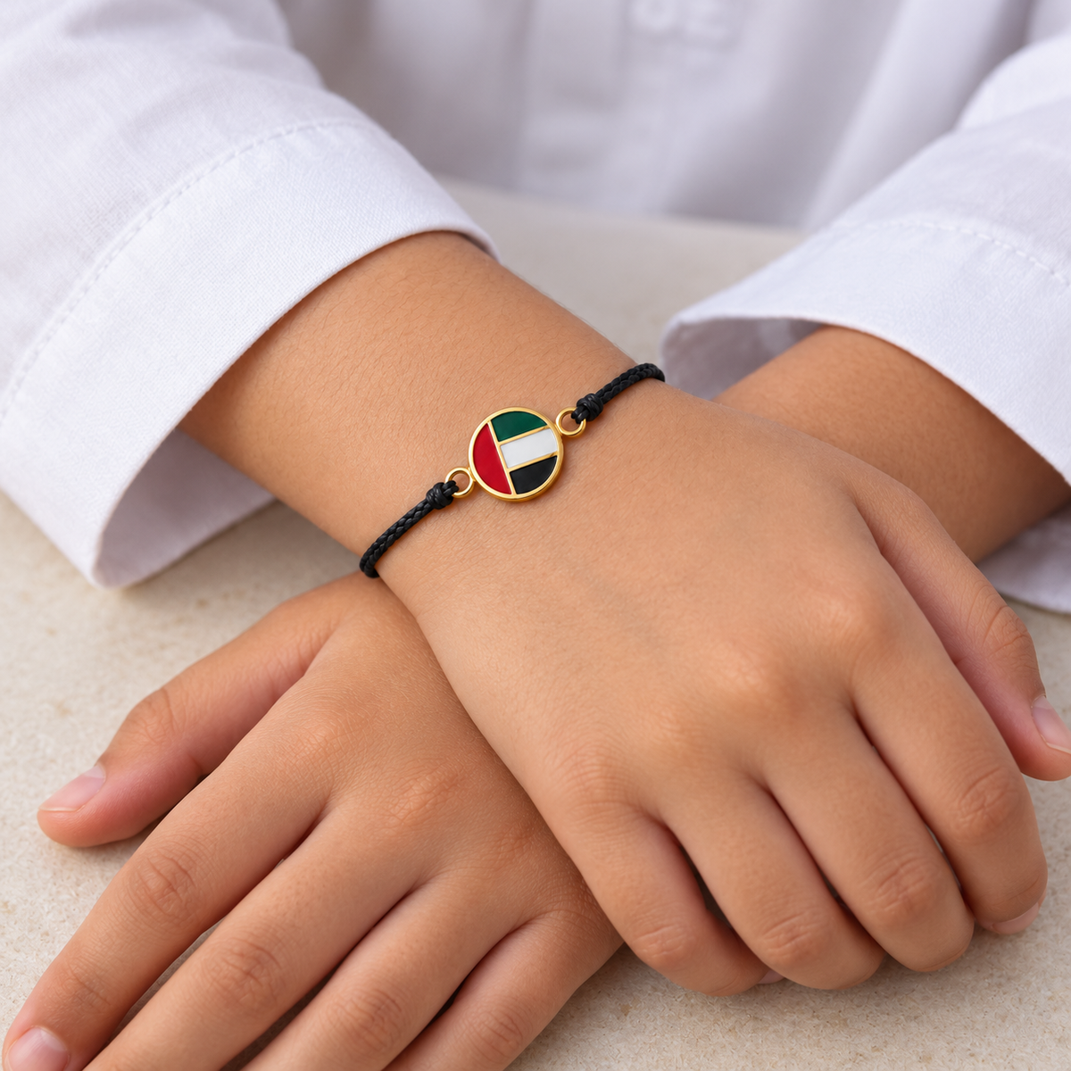 Generated child model wearing UAE flag cord bracelet — styling mockup