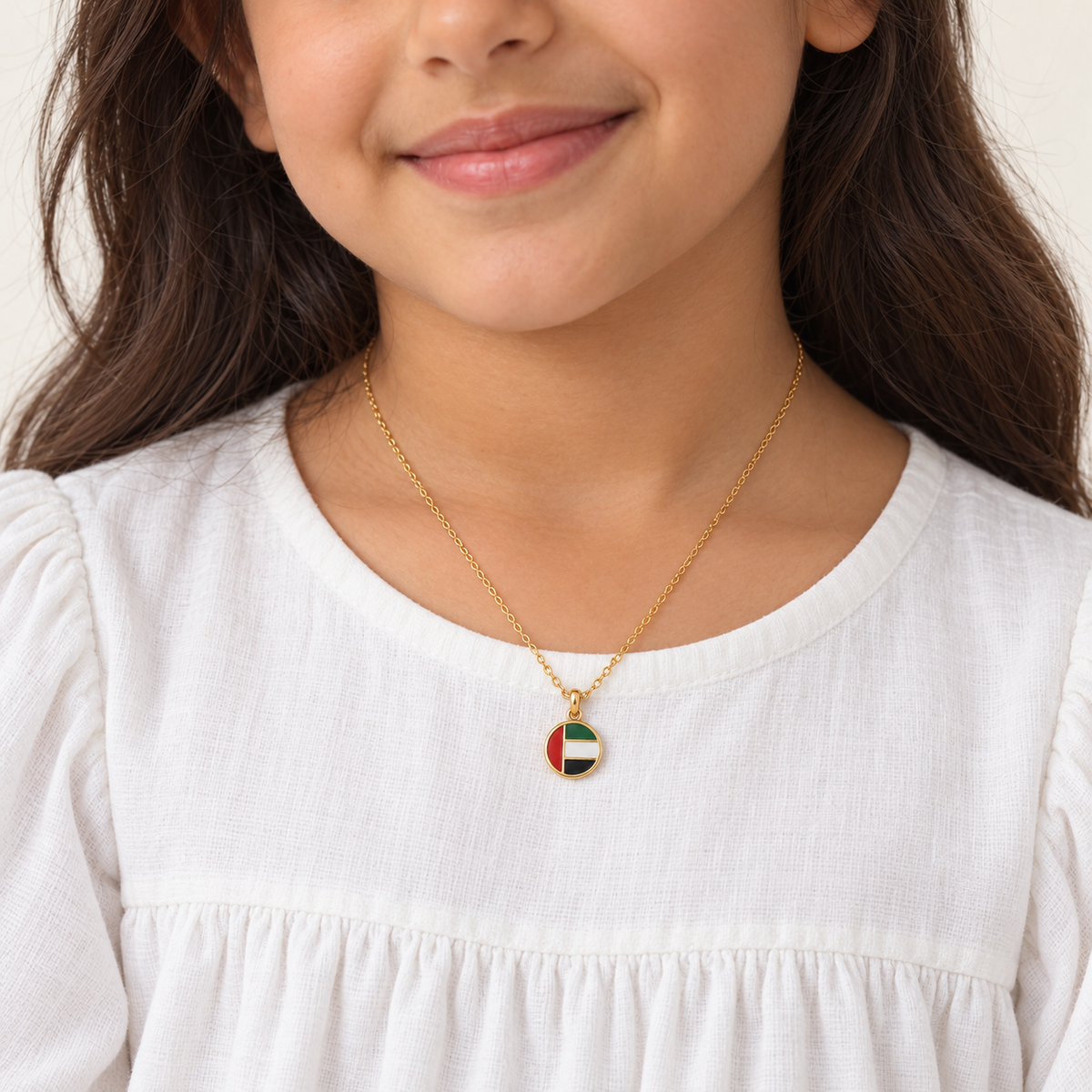 Generated child model wearing round UAE flag necklace — styling mockup