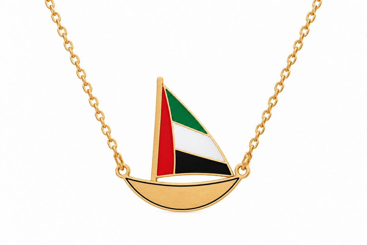 Approved Little Sail flat laser-cut UAE flag dhow necklace, gold plated with thin black enamel hull outline, on white background