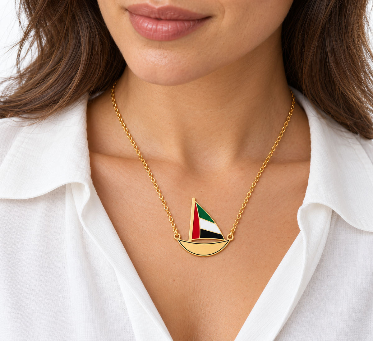 Woman wearing approved Little Sail 3 × 3 cm gold plated dhow necklace, flat laser-cut hull with thin black enamel outline — generated styling image