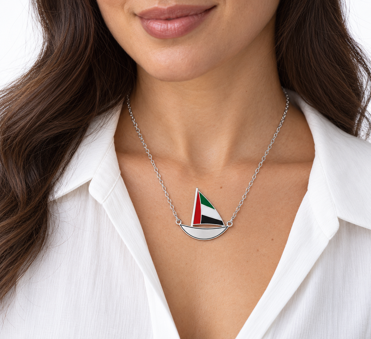 Woman wearing approved Little Sail 3 × 3 cm silver finish dhow necklace with thin black enamel hull outline — generated styling image