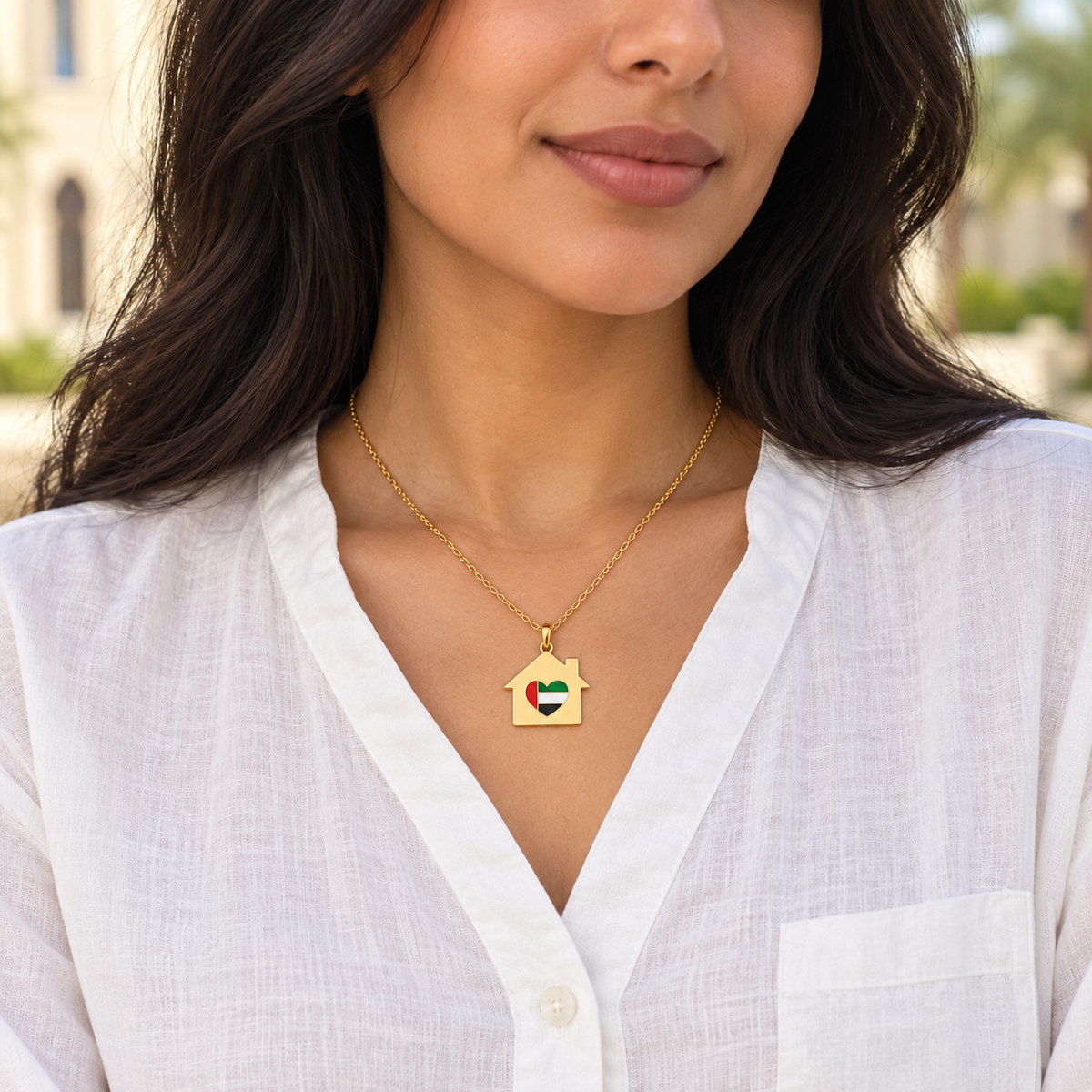 Woman wearing My UAE Home 3 × 3 cm gold plated house necklace with UAE flag heart — generated styling image