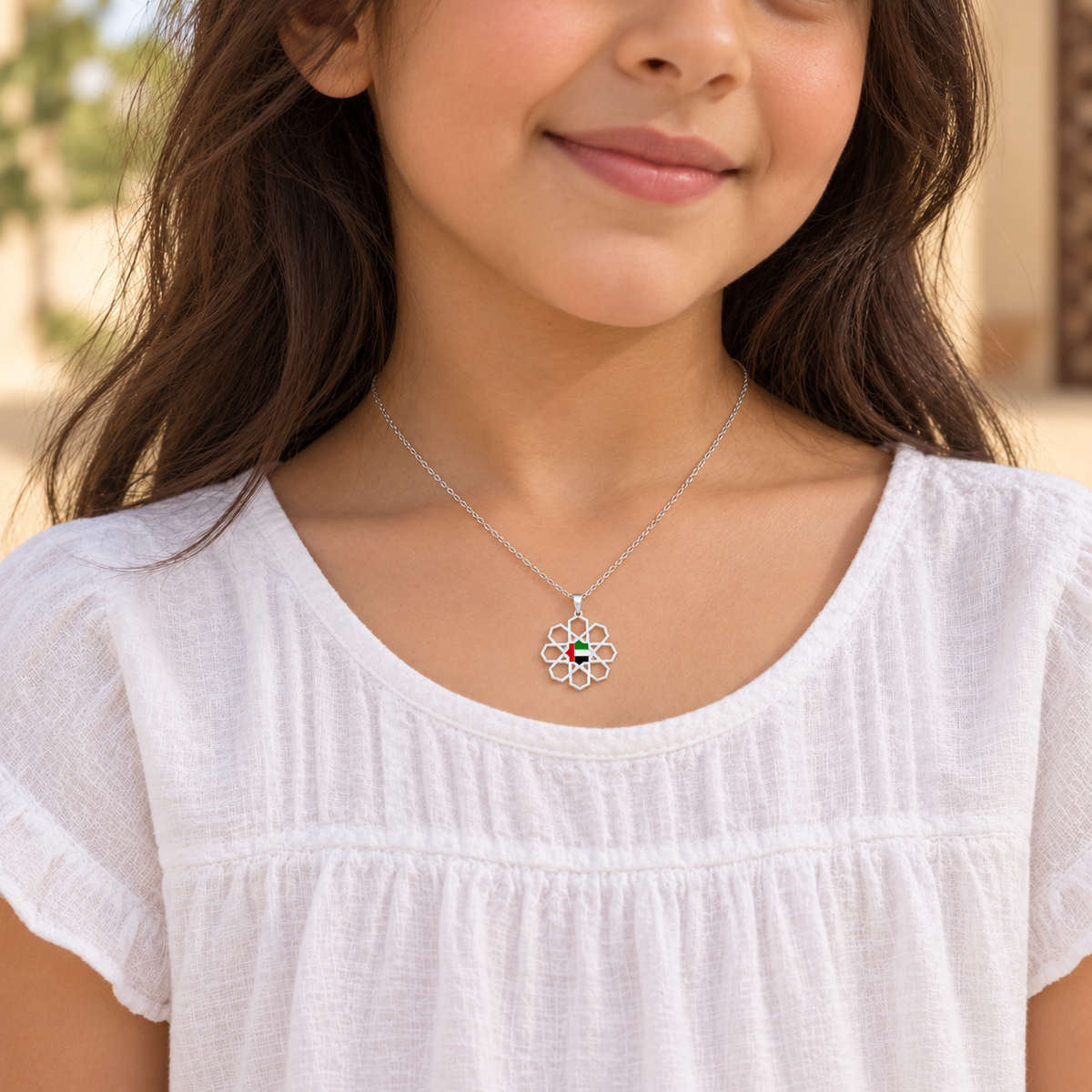 Child wearing delicate 1.5 cm UAE Arabesque Star necklace in silver finish — generated styling image